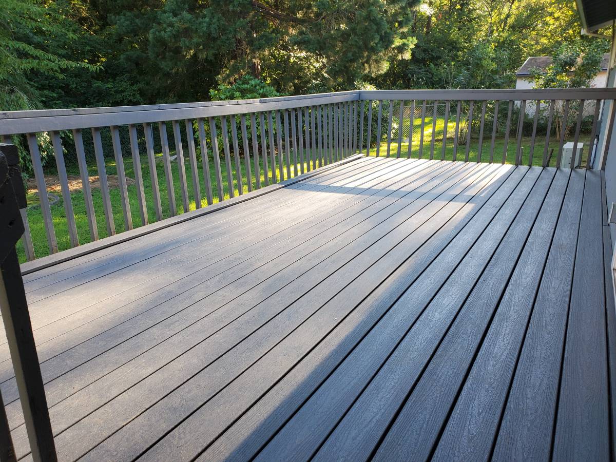 Finished backyard deck with gray boards and railing