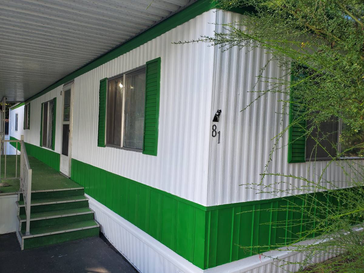 Mobile home exterior painted white and green